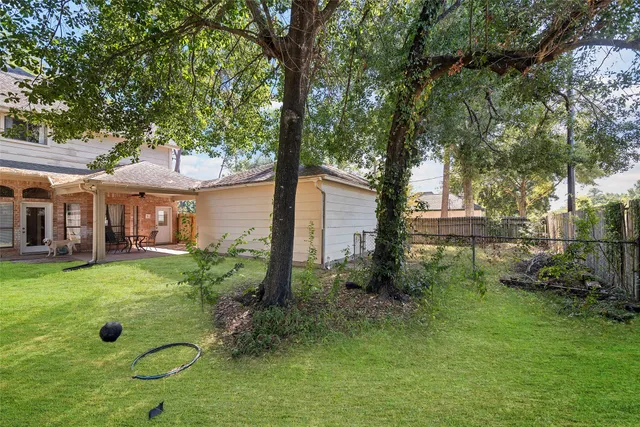 a view of backyard of house with green space