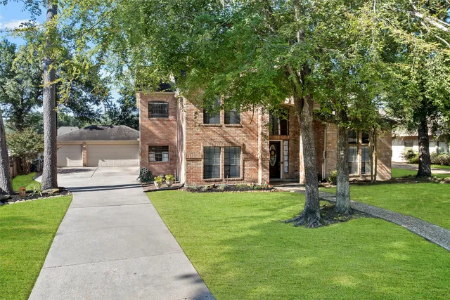 a front view of a building with a garden