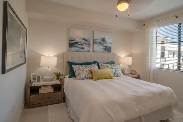 a bedroom with a bed and a lamp