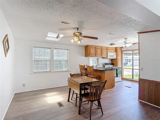 a dining room with furniture and wooden floor