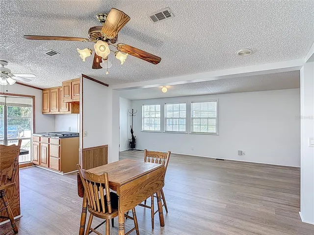 a view of a dining room with furniture wooden floor and chandelier
