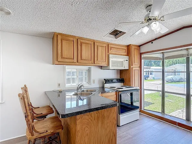 a kitchen with a stove a sink and a refrigerator