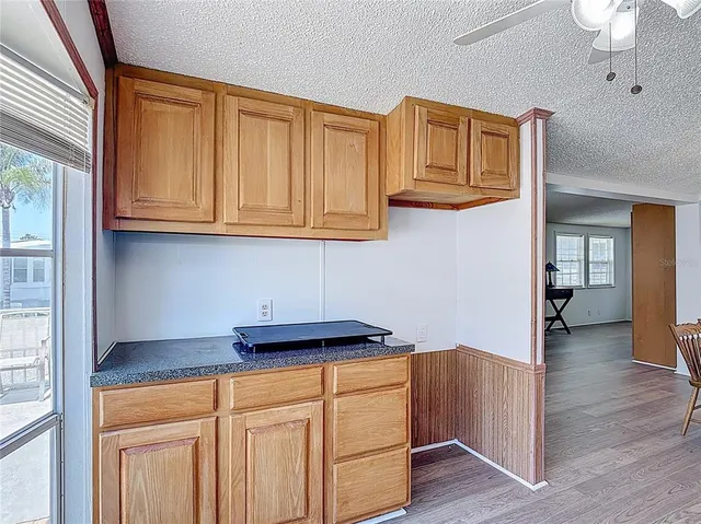 a kitchen with stainless steel appliances granite countertop a refrigerator and cabinets