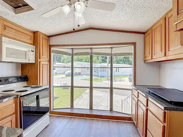 a kitchen that has a stove and a wooden floor