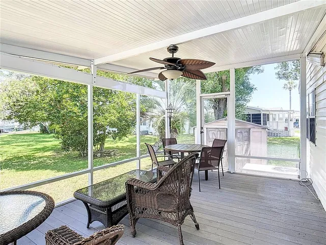 a view of a dining room with furniture wooden floor and a floor to ceiling window