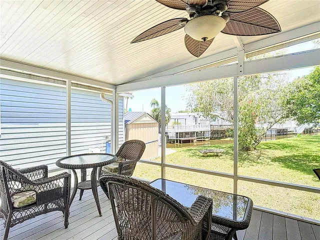 a view of a dining room with furniture and floor to ceiling windows