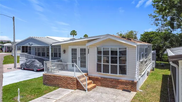 a front view of a house with a yard table and chairs