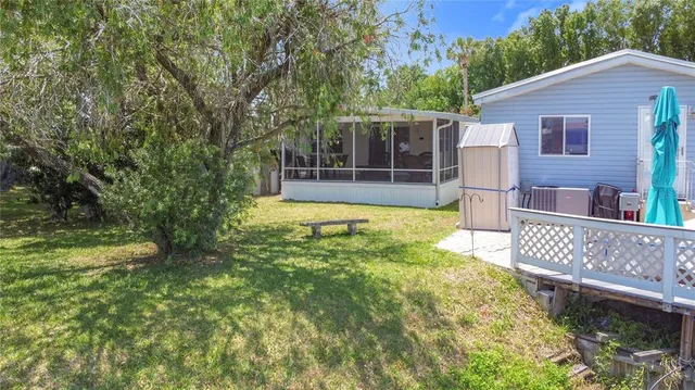 a view of a house with backyard and sitting area