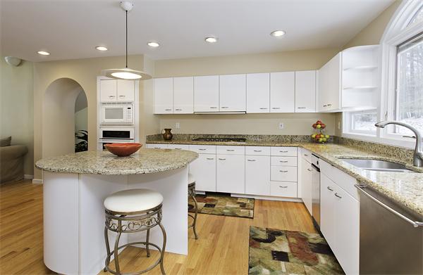 328 Border Road Concord, MA 01742 - Photo 6 of 14 a kitchen with stainless steel appliances granite countertop a sink a stove a refrigerator and white cabinets with wooden floor