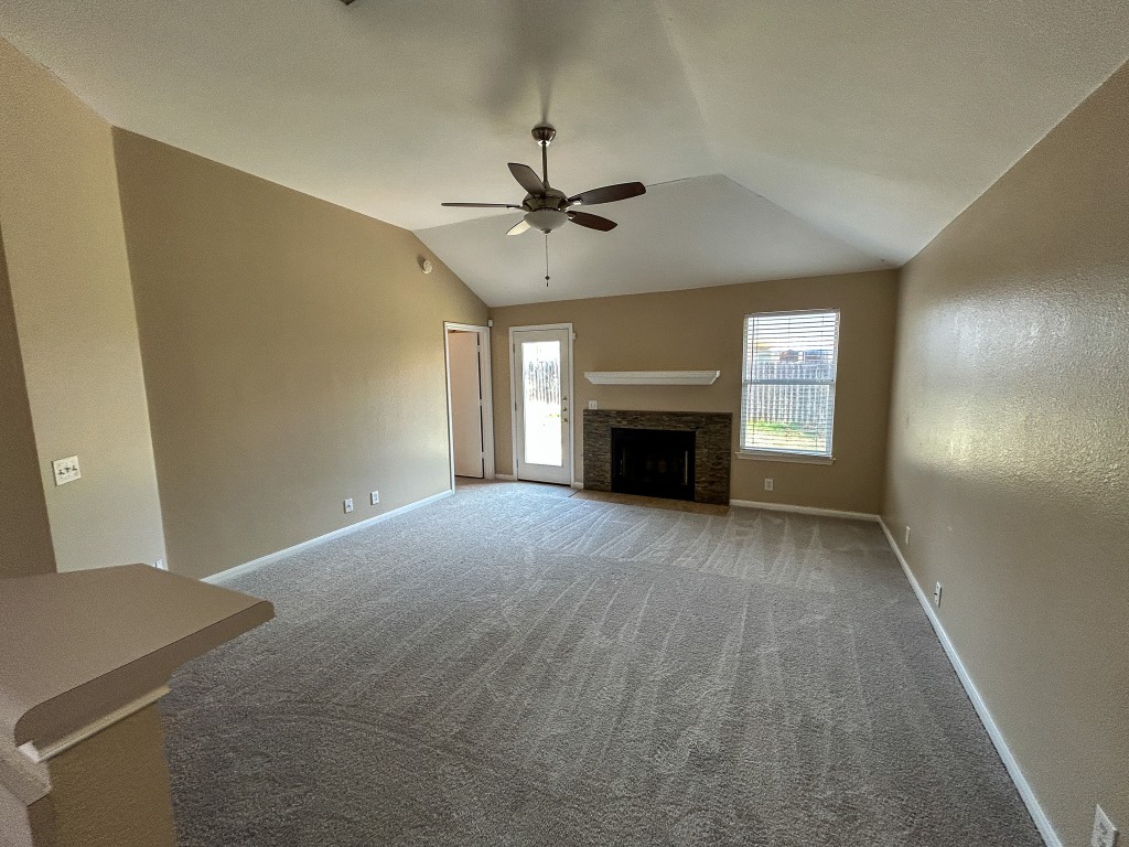 1604 Harness Race Way Pflugerville, TX 78660 - Photo 12 of 25 a view of empty room with a fireplace and fan