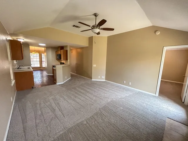 a view of a kitchen with a sink stainless steel appliances