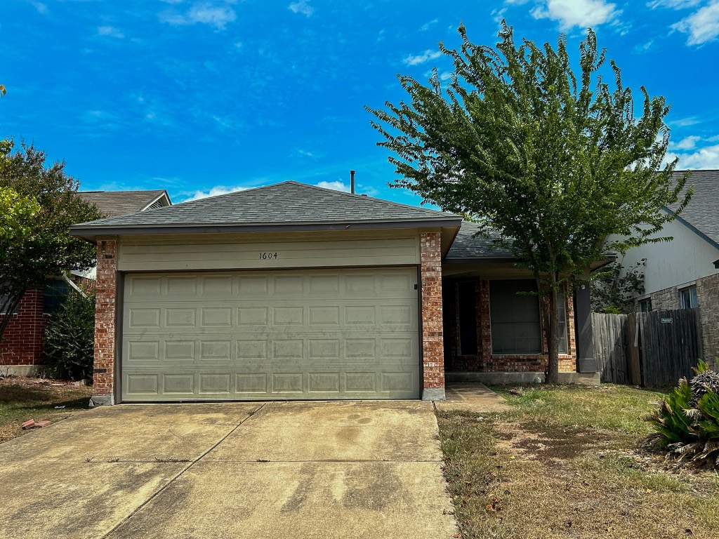 1604 Harness Race Way Pflugerville, TX 78660 - Photo 2 of 25 a front view of a house with a yard and garage
