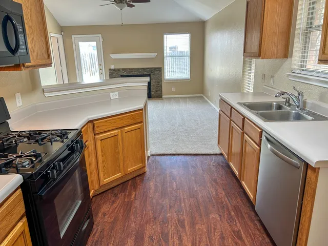 a kitchen with wooden floors and a stove