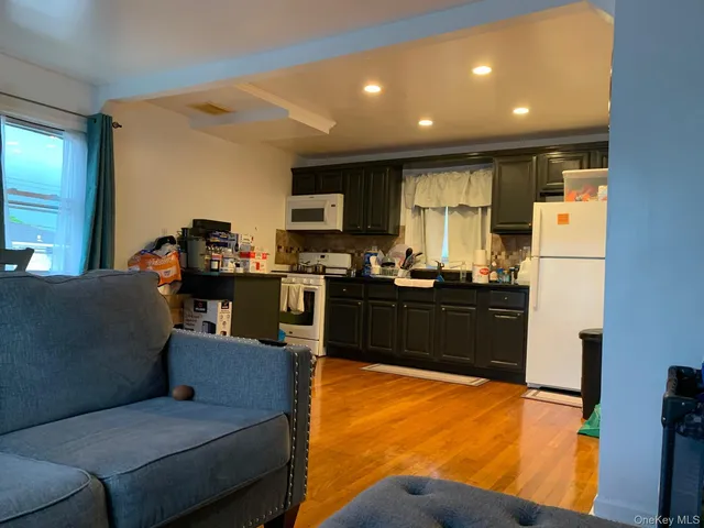 a living room with furniture and kitchen view