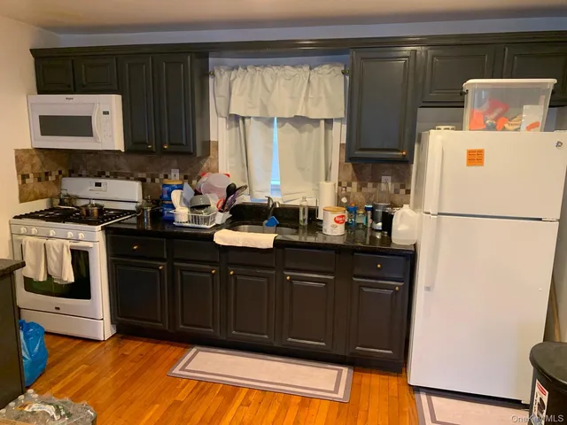 a kitchen with a refrigerator and a sink