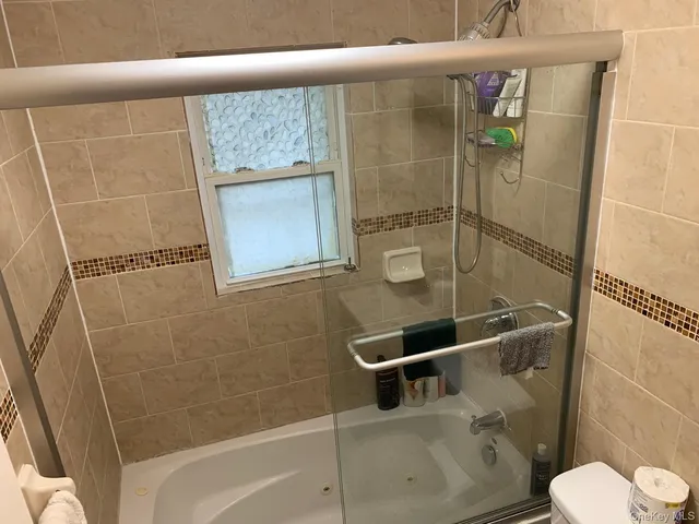 a bathroom with a shower and toilet