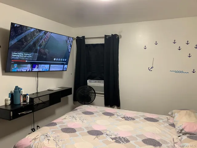 a bedroom with a bed and cabinets