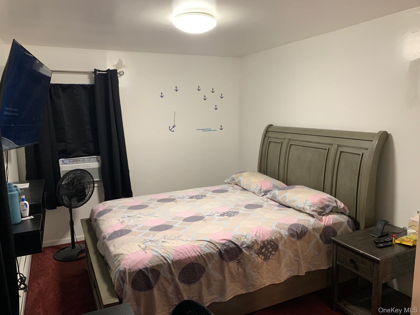 217-05 104th Avenue Queens, NY 11429 - Photo 21 of 43 a bedroom with a bed and wooden floor