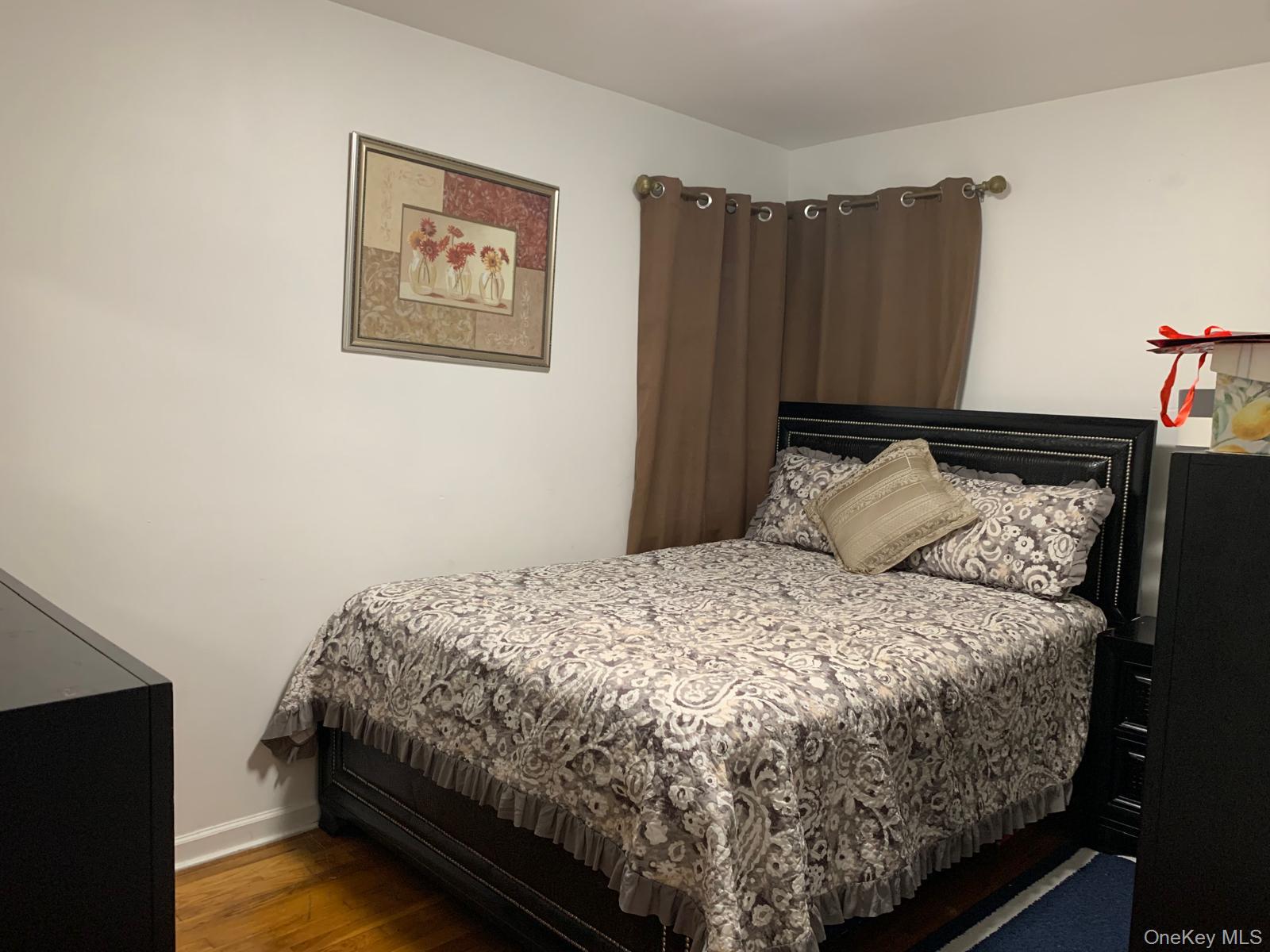 217-05 104th Avenue Queens, NY 11429 - Photo 27 of 43 a bedroom with bed and wooden floor