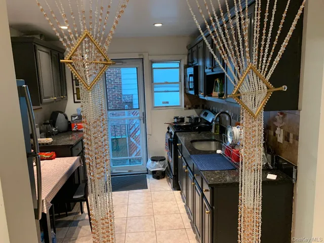 a kitchen with stainless steel appliances granite countertop a stove and a refrigerator