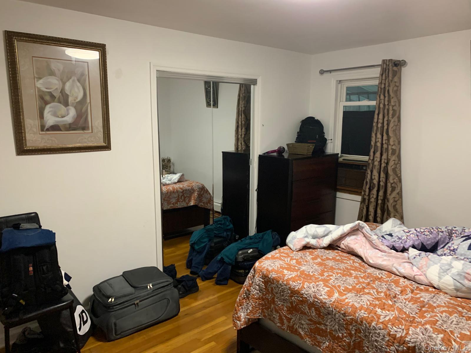 217-05 104th Avenue Queens, NY 11429 - Photo 30 of 43 a bedroom with a bed and wooden floor