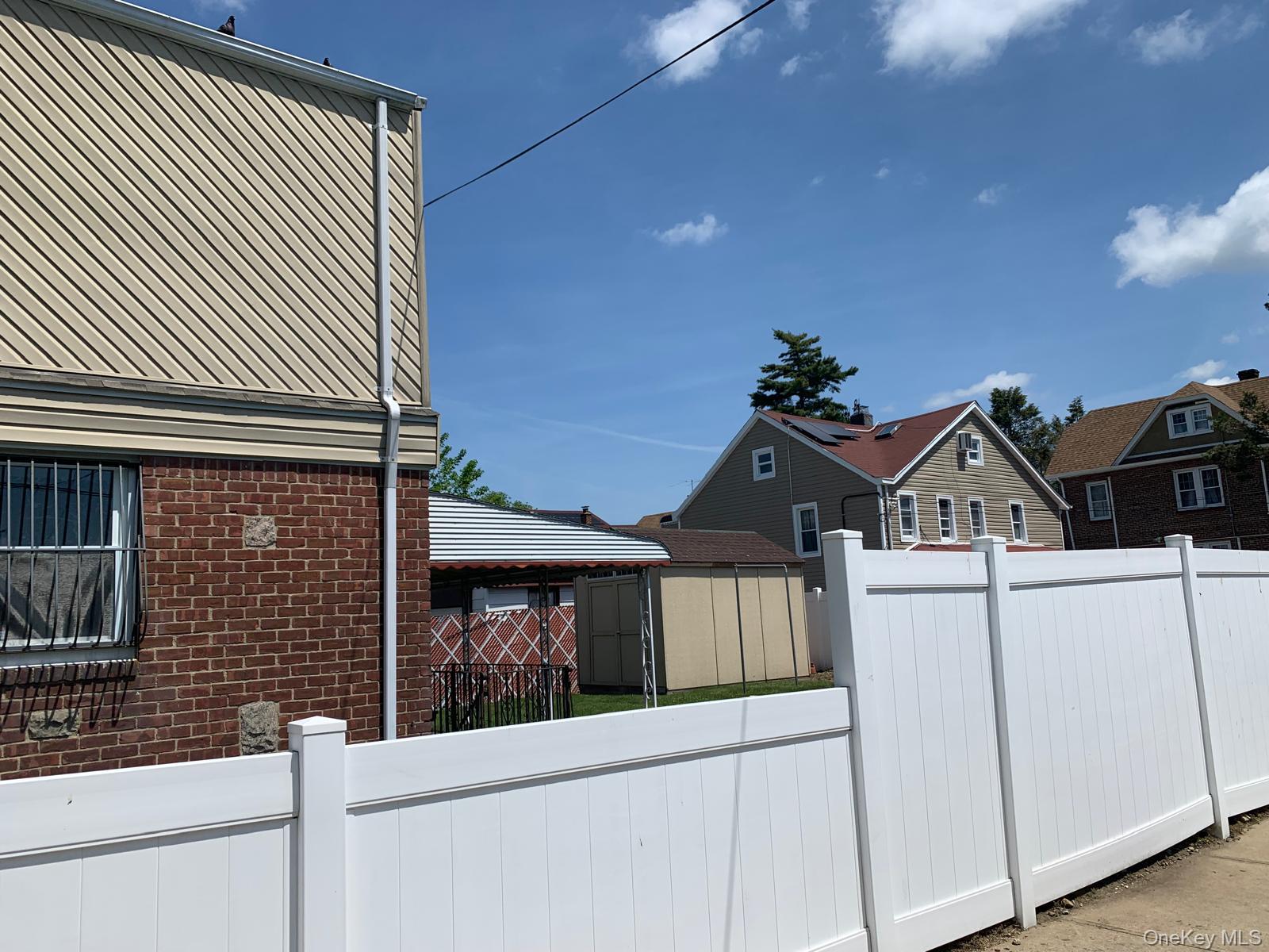 217-05 104th Avenue Queens, NY 11429 - Photo 3 of 43 a front view of a house with a garage