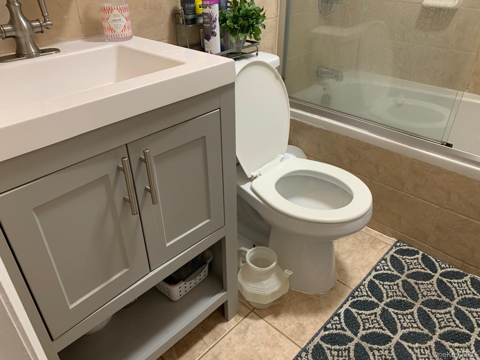 217-05 104th Avenue Queens, NY 11429 - Photo 31 of 43 a bathroom with a sink and a mirror