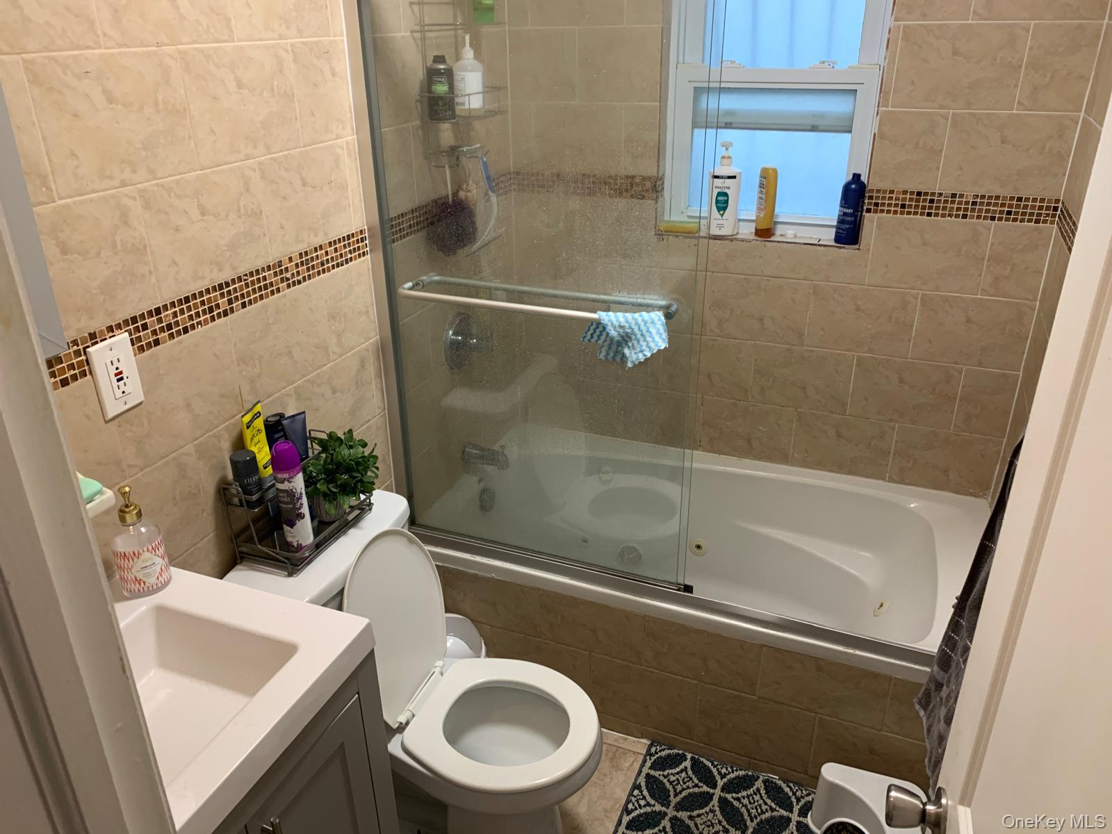 217-05 104th Avenue Queens, NY 11429 - Photo 32 of 43 a bathroom with a sink a toilet and shower