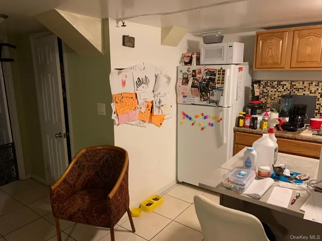 a room with furniture and a refrigerator