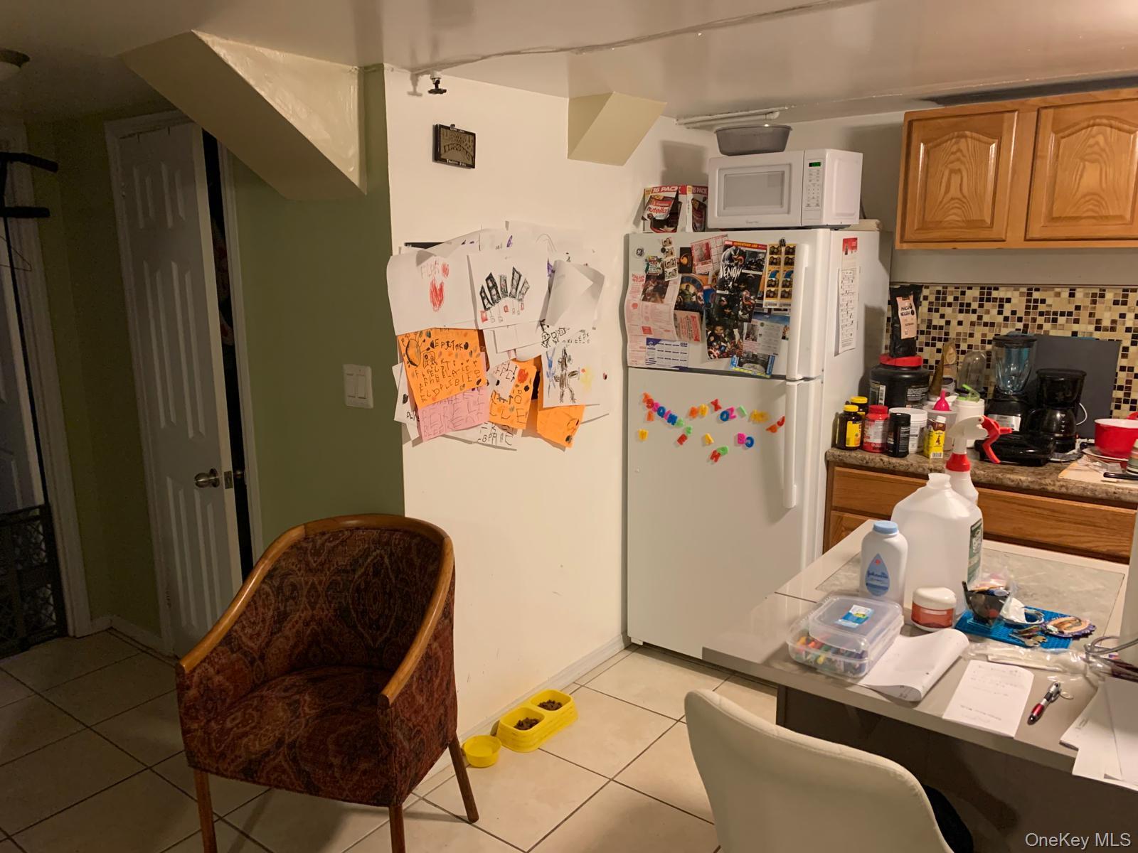 217-05 104th Avenue Queens, NY 11429 - Photo 33 of 43 a room with furniture and a refrigerator