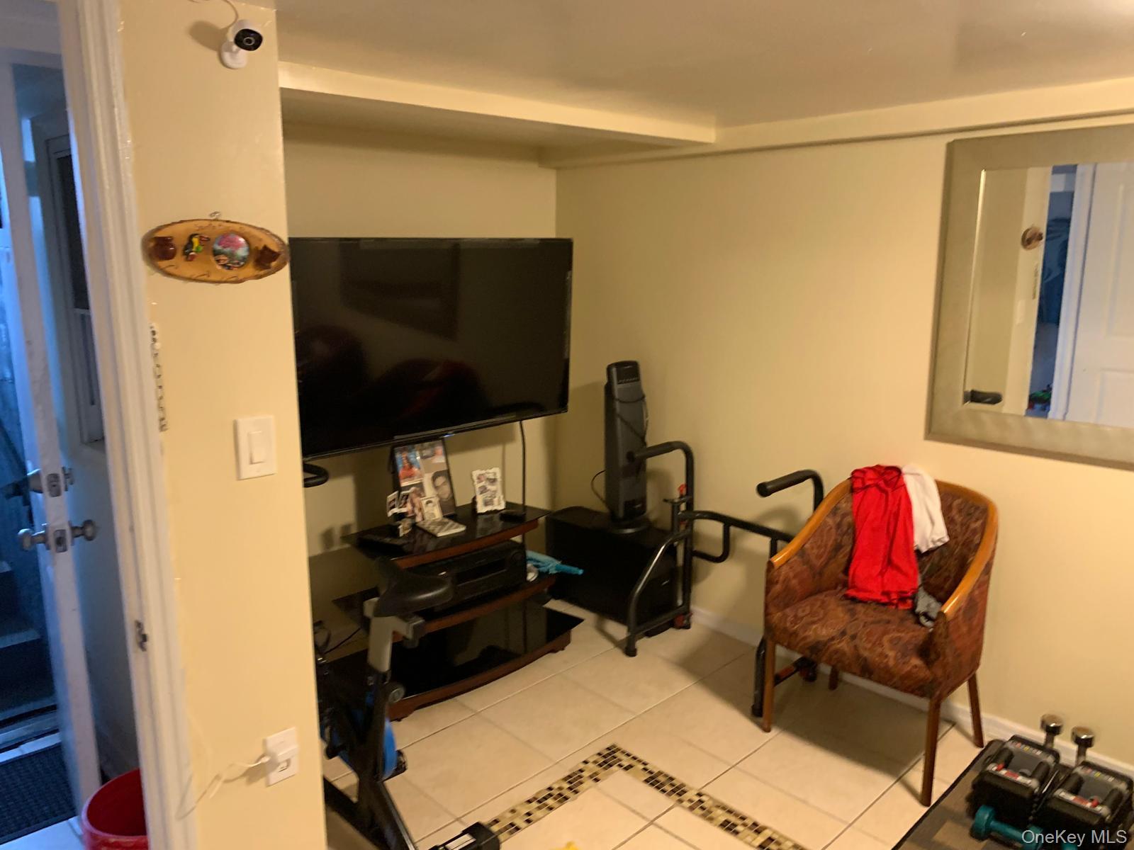 217-05 104th Avenue Queens, NY 11429 - Photo 34 of 43 a living room with furniture and a flat screen tv