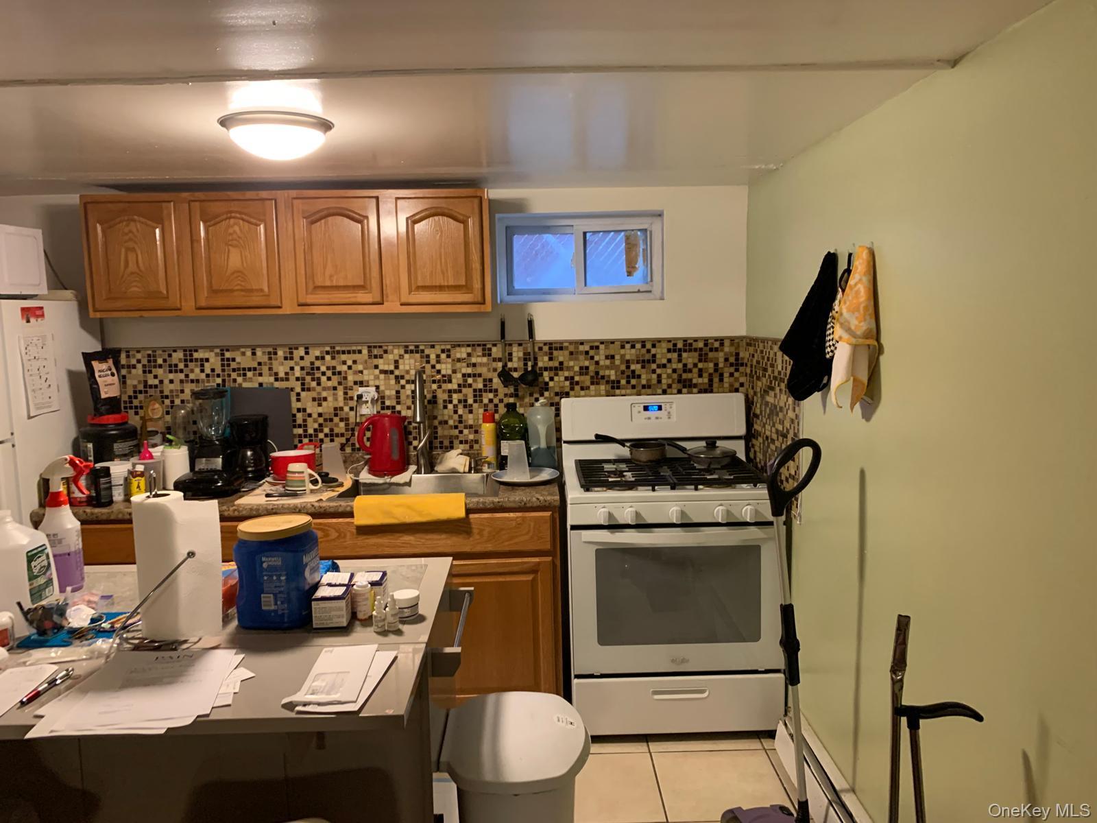 217-05 104th Avenue Queens, NY 11429 - Photo 36 of 43 a kitchen that has a stove and a microwave