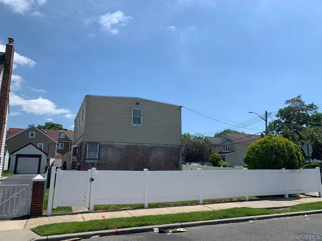 a aerial view of a house with a yard and a large tree