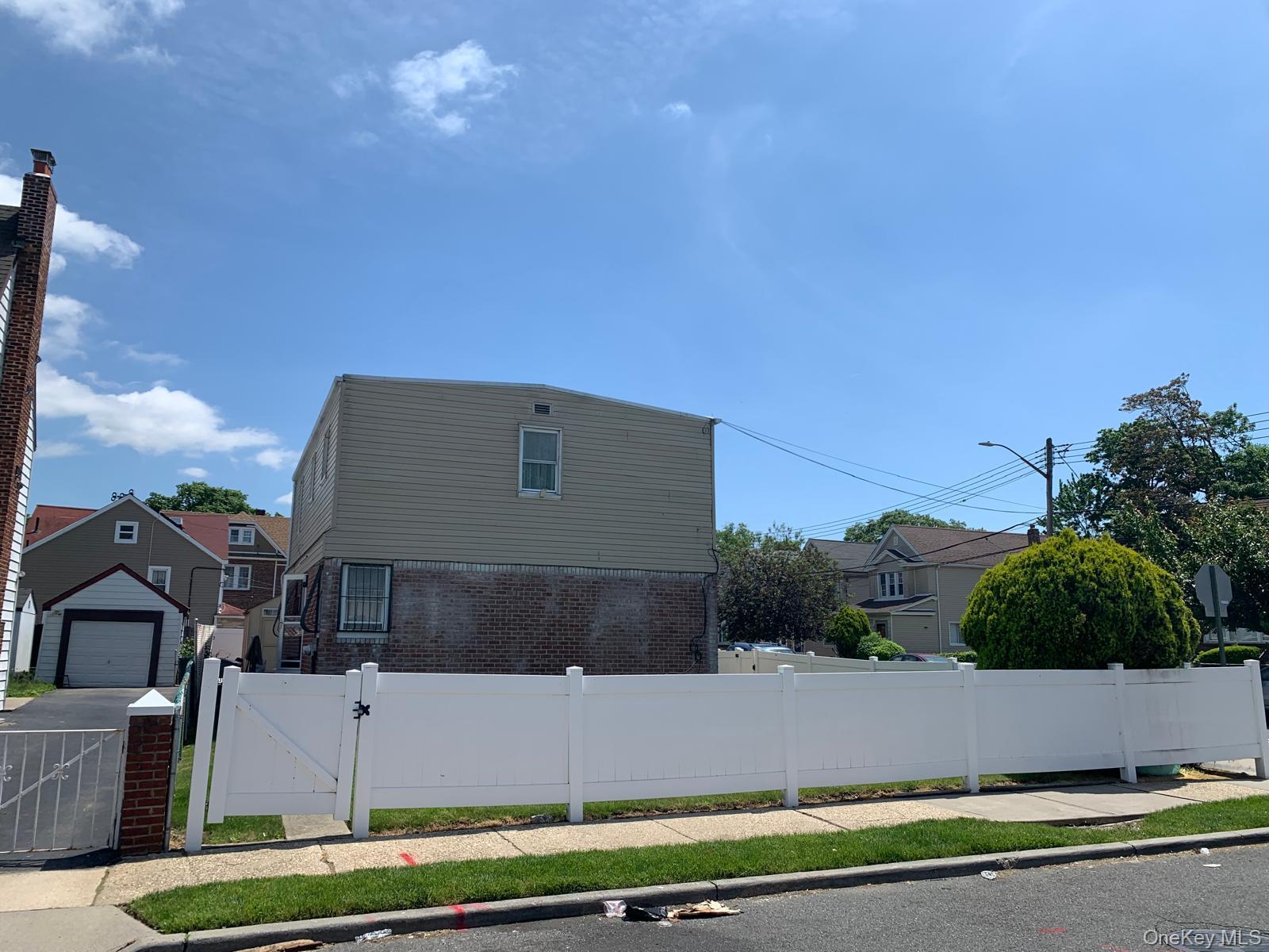 217-05 104th Avenue Queens, NY 11429 - Photo 6 of 43 a aerial view of a house with a yard and a large tree