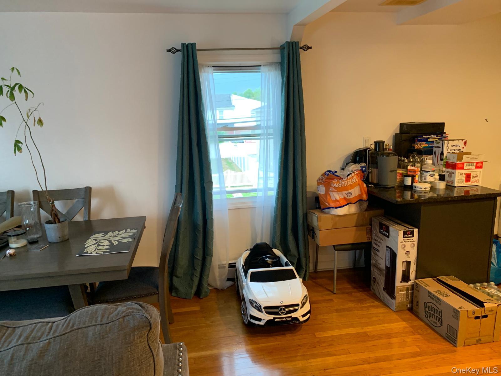 217-05 104th Avenue Queens, NY 11429 - Photo 9 of 43 a living room with furniture and a flat screen tv