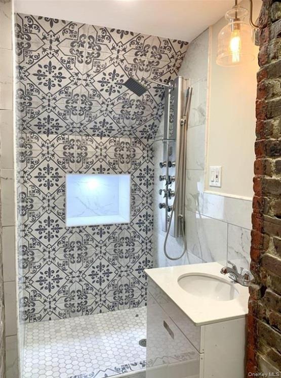 2301 Bathgate Avenue Bronx, NY 10458 - Photo 10 of 25 a bathroom with a sink and a mirror