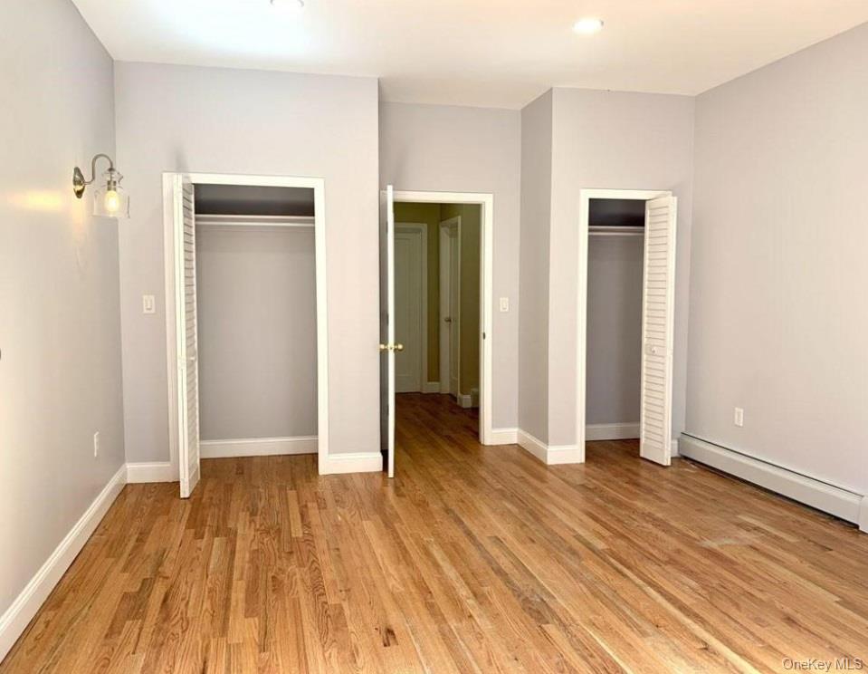 2301 Bathgate Avenue Bronx, NY 10458 - Photo 13 of 25 an empty room with wooden floor and closet