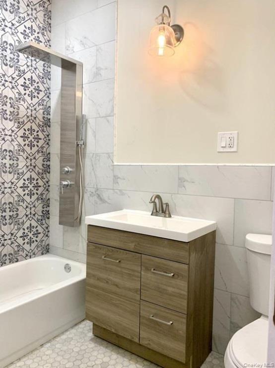 2301 Bathgate Avenue Bronx, NY 10458 - Photo 14 of 25 a bathroom with a sink a toilet and bathtub