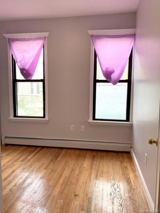 2301 Bathgate Avenue Bronx, NY 10458 - Photo 15 of 25 a view of a room with wooden floor and a window