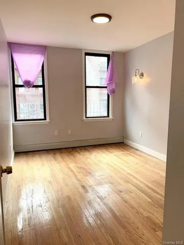 wooden floor and window in an empty room