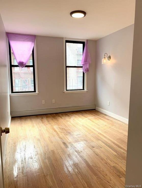 2301 Bathgate Avenue Bronx, NY 10458 - Photo 17 of 25 wooden floor and window in an empty room