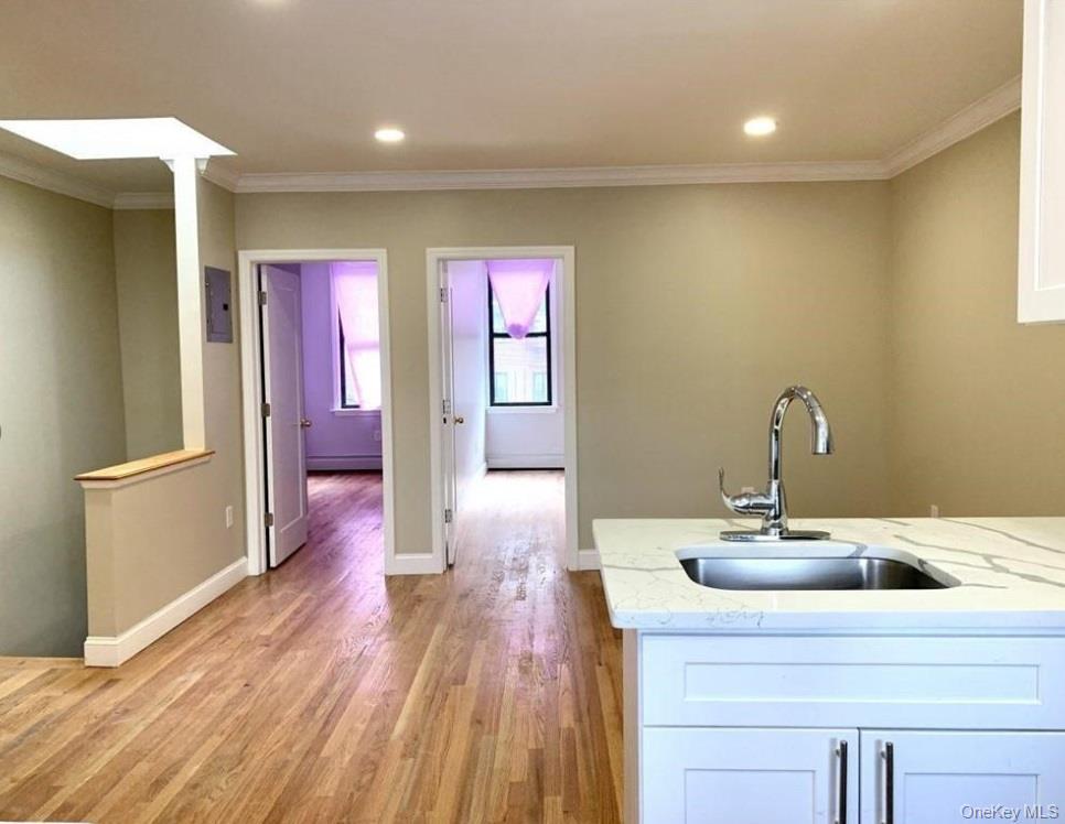 2301 Bathgate Avenue Bronx, NY 10458 - Photo 20 of 25 a kitchen with a sink and wooden floor