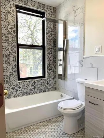 a bathroom with a toilet a sink and bathtub