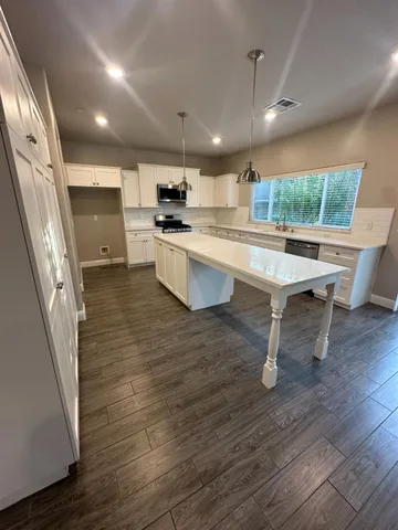 a kitchen with a sink appliances and cabinets