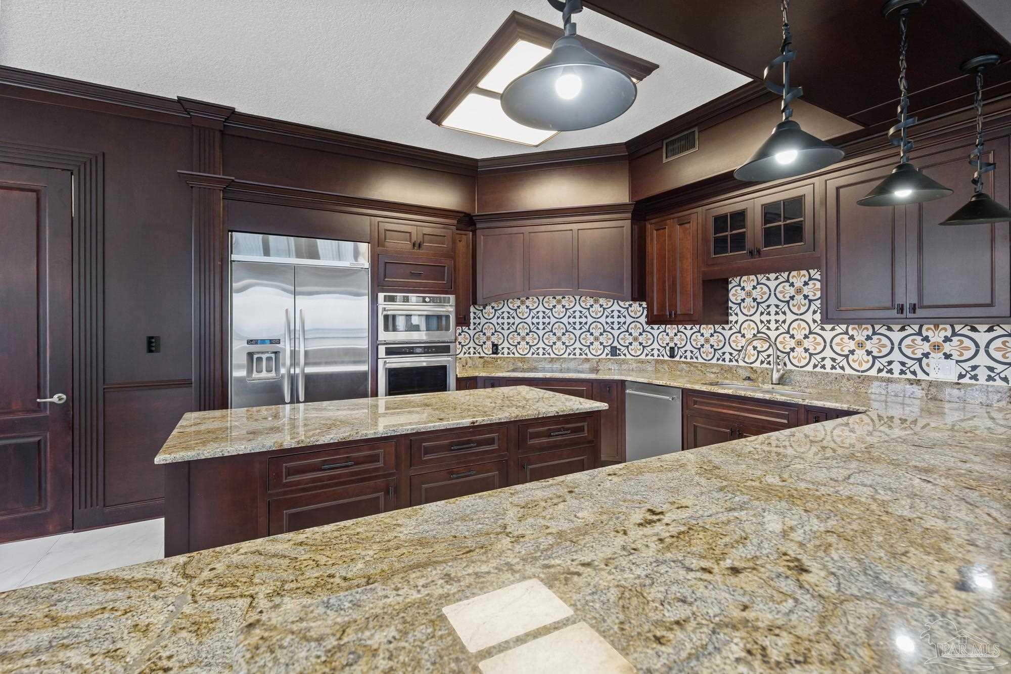 14900 River Road, Unit 904 Perdido Key, FL 32507 - Photo 13 of 62 a kitchen with stainless steel appliances kitchen island granite countertop a sink and cabinets