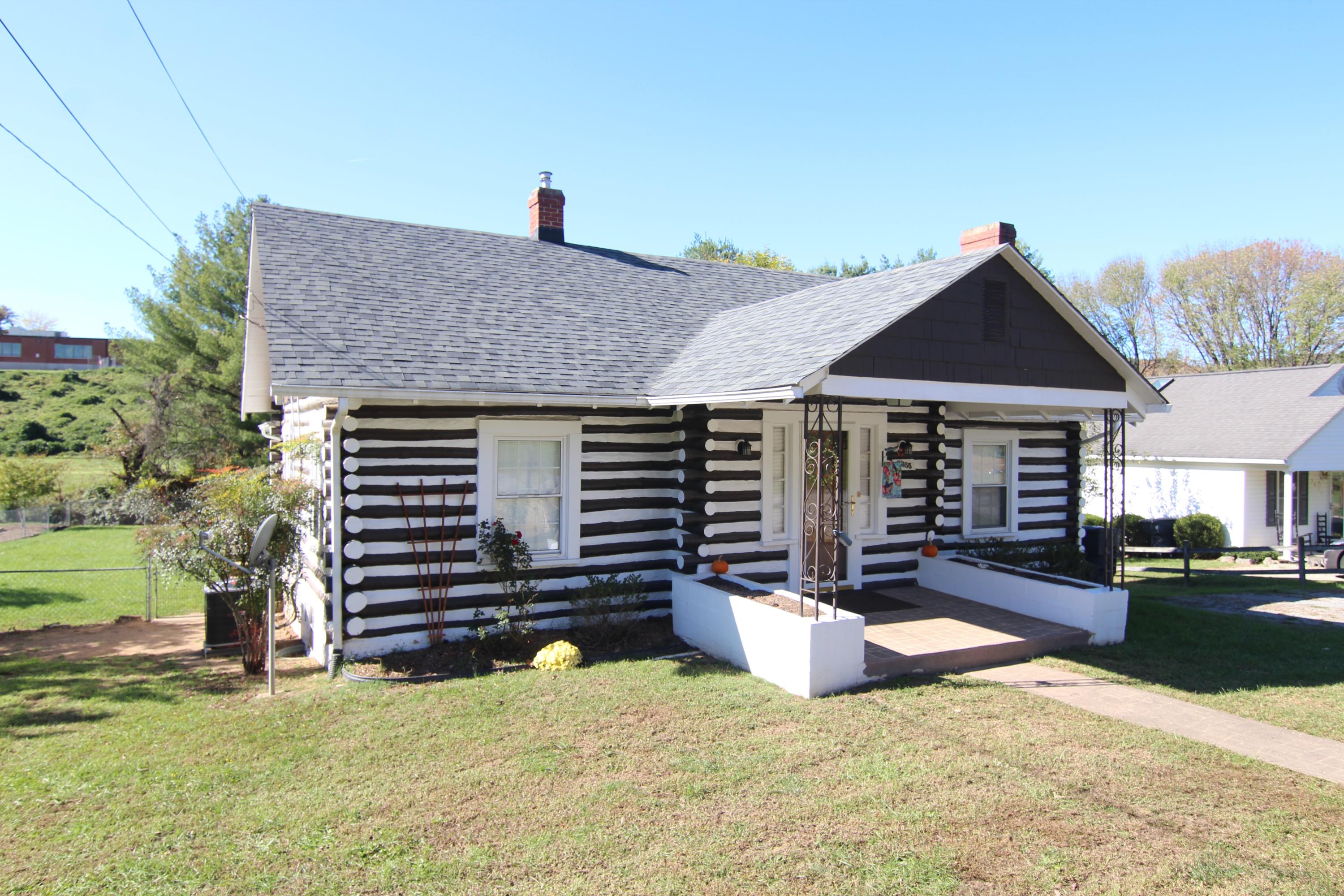 a view of a house with a yard and sitting area
