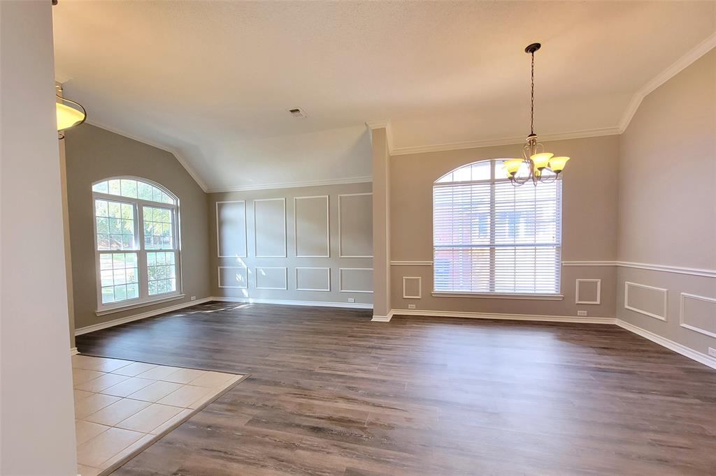 1604 Knoll Ridge Circle Corinth, TX 76210 - Photo 8 of 37 Spacious living area featuring wood-finish flooring, vaulted ceilings, and crown molding