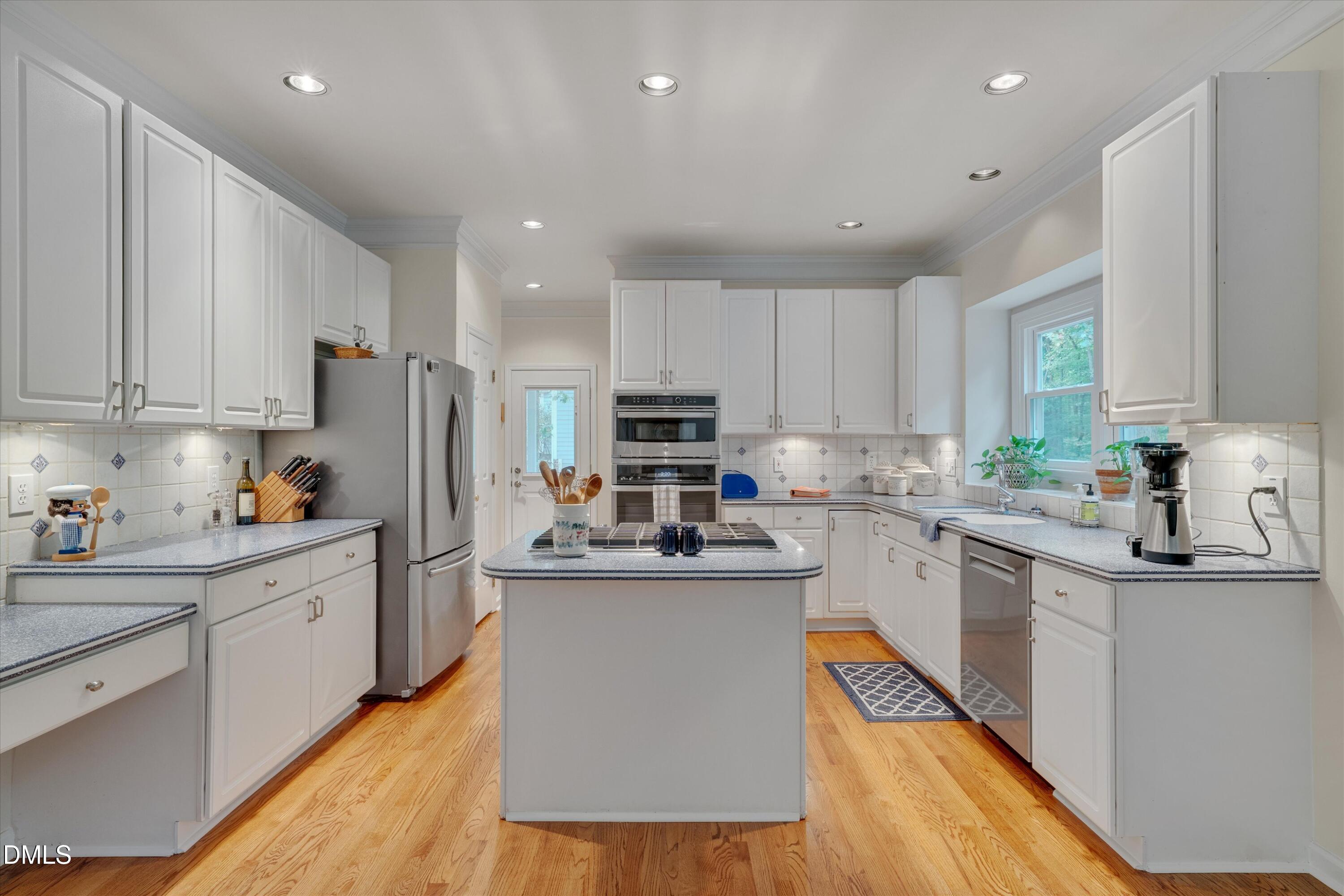 205 Cates Farm Road Chapel Hill, NC 27516 - Photo 16 of 56 a kitchen with stainless steel appliances granite countertop a refrigerator a sink dishwasher a stove and white cabinets with wooden floor