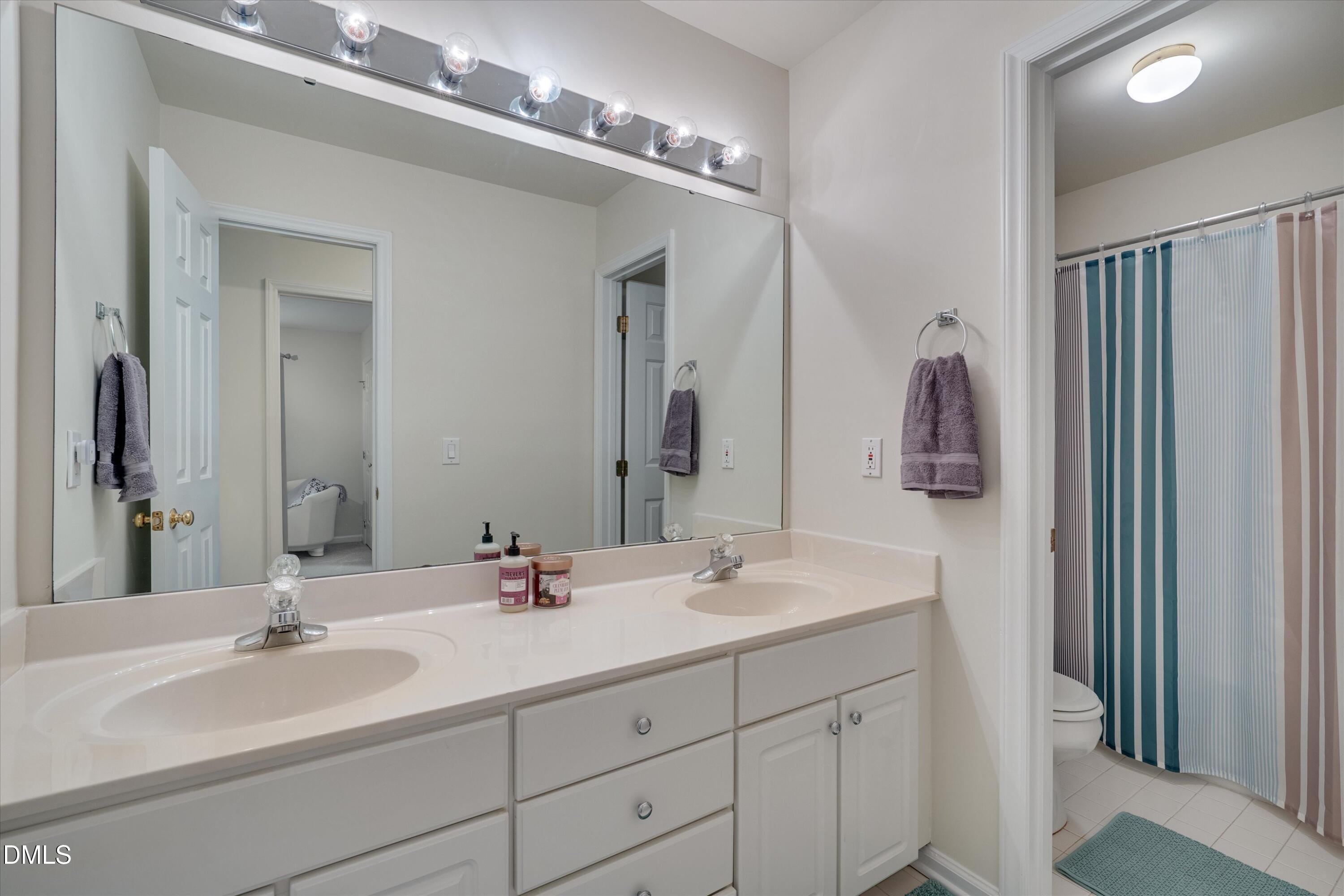 205 Cates Farm Road Chapel Hill, NC 27516 - Photo 38 of 56 a bathroom with double vanity sinks and a mirror