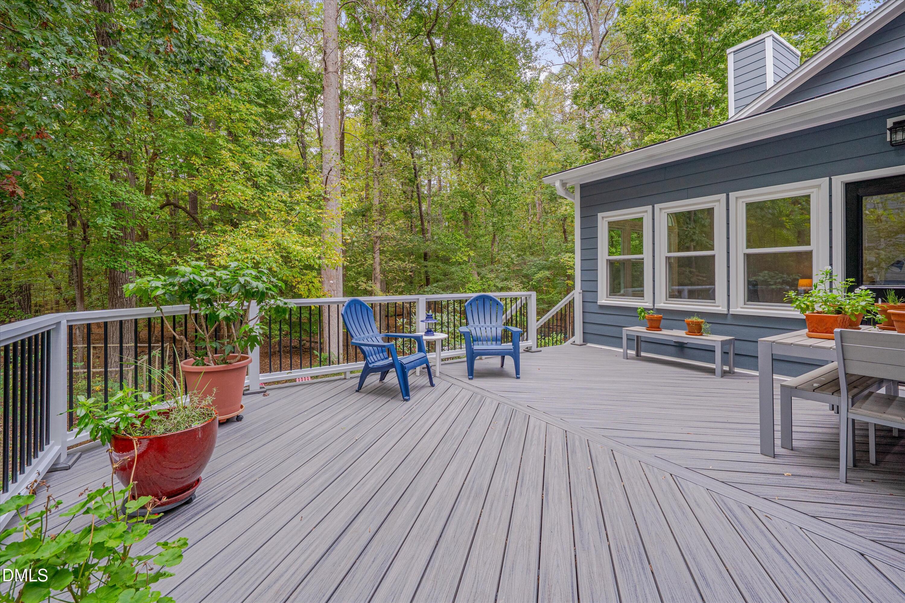 205 Cates Farm Road Chapel Hill, NC 27516 - Photo 42 of 56 a view of a roof deck with table and chairs and wooden floor